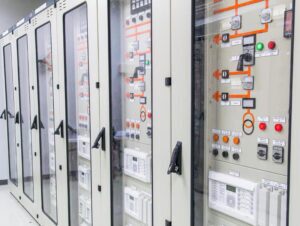 Industrial PLC control panel and electrical cabinet inside manufacturing facility