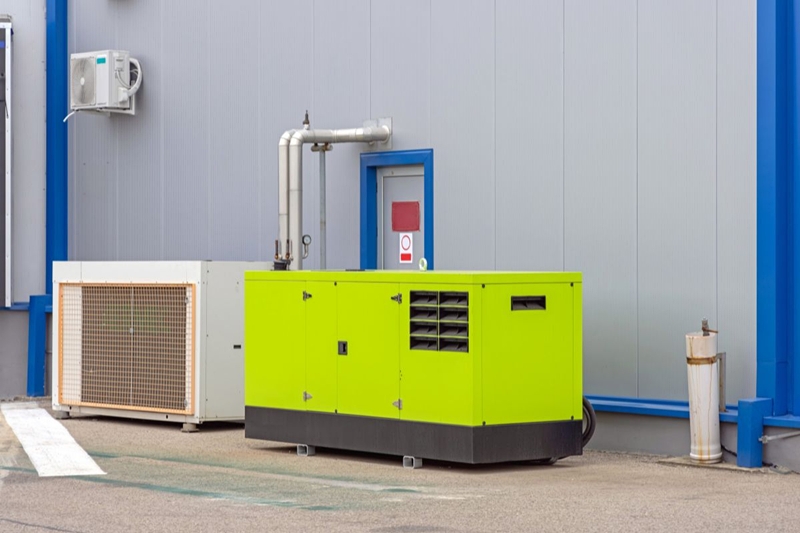 Standby diesel generator installed outside a commercial building for emergency backup power