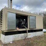 Standby diesel generator installed outside a commercial facility for emergency backup power