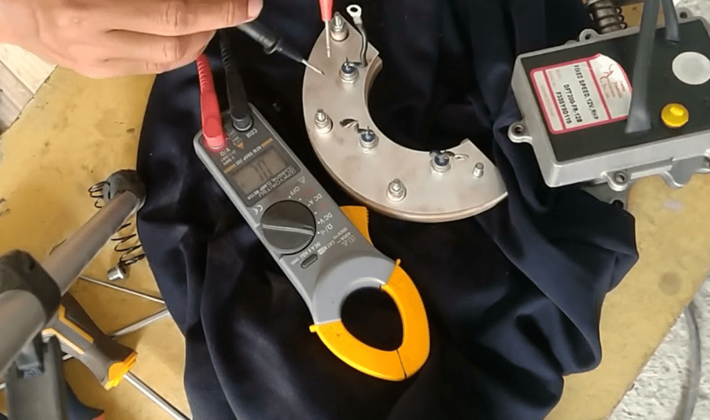 Technician testing generator rotating diode with a multimeter