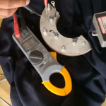 Technician testing generator rotating diode with a multimeter
