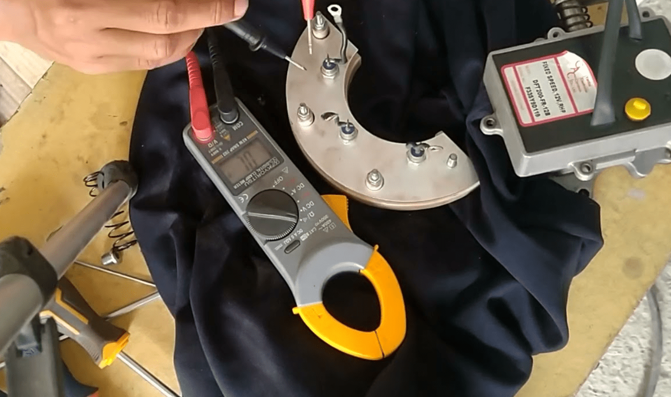 Technician testing generator rotating diode with a multimeter